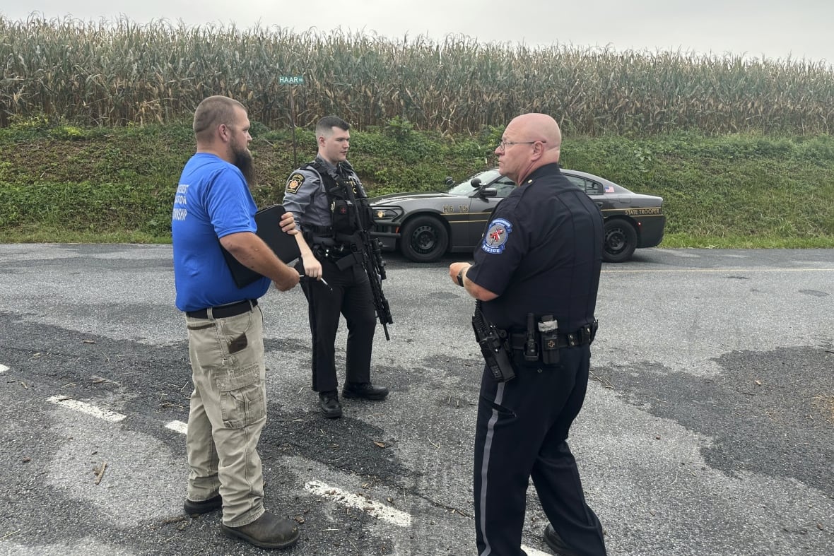 The police stand near the crime scene.