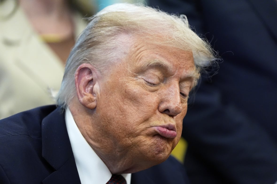 An elderly man looks down.