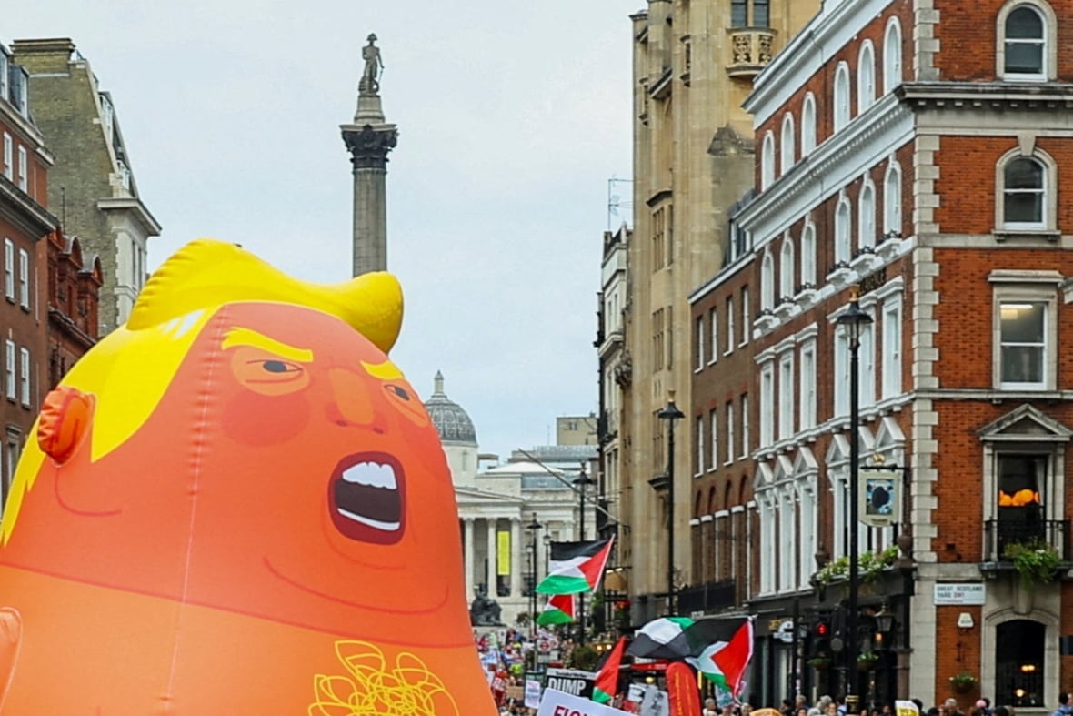 The balloon, which depicts US President Donald Trump and the Palestinian flags, is held in protest 