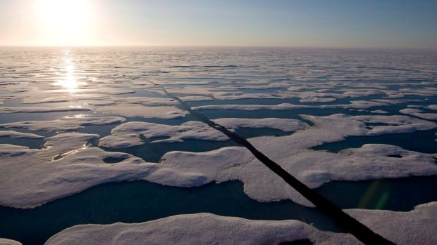 The sun can be seen shinning over thousands of pieces of floating sea ice in the arctic.