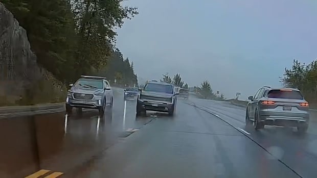 A vehicle crosses a double hatched yellow line into on coming traffic. 