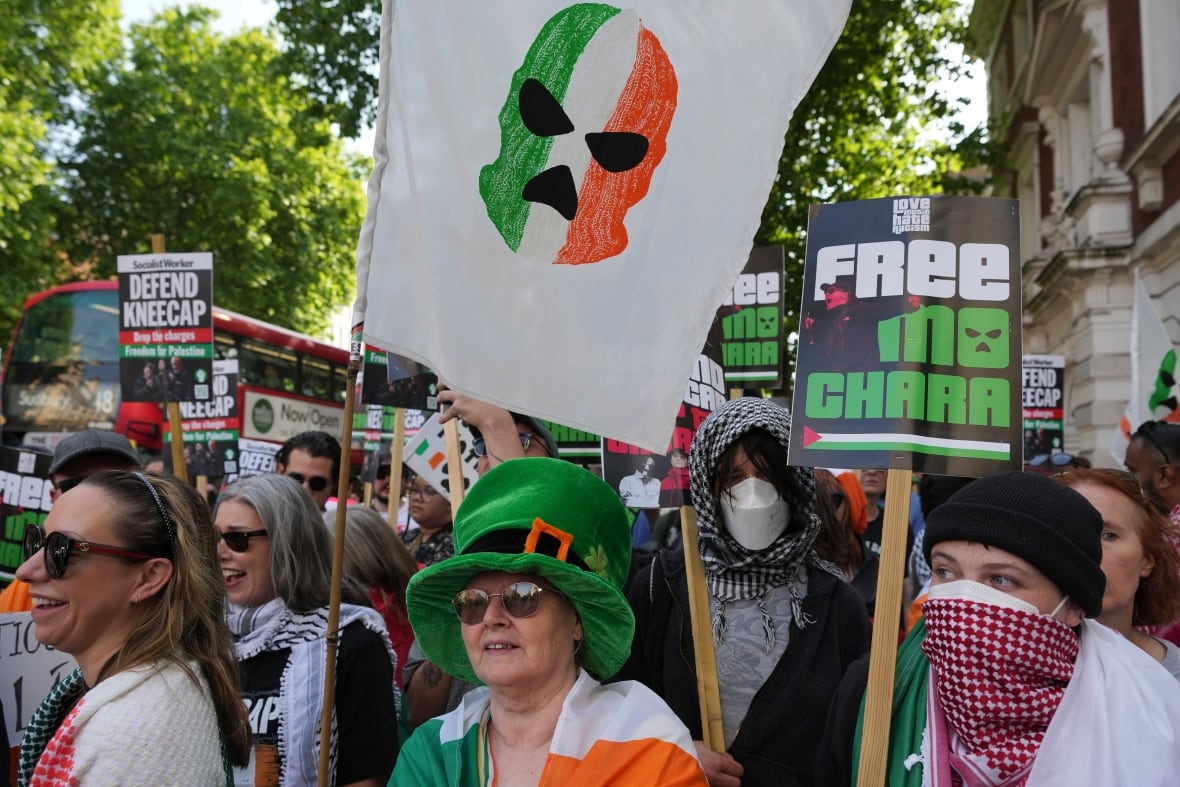 People hold signs.