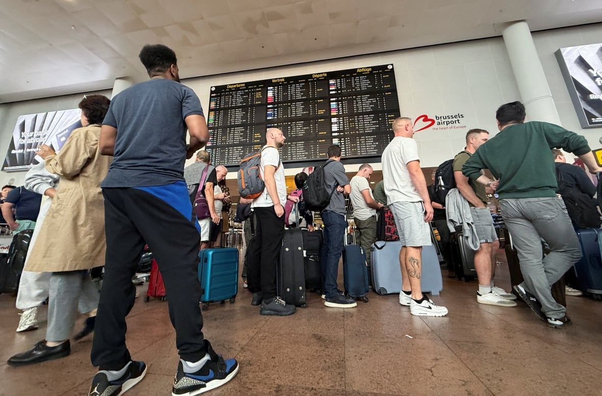 Travelers are waiting for queues at Brussels Airport.