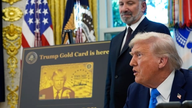 President Donald Trump speaks as Commerce Secretary Howard Lutnick listens in the Oval Office of the White House, Friday, Sept. 19, 2025, in Washington. (AP Photo/Alex Brandon) two people