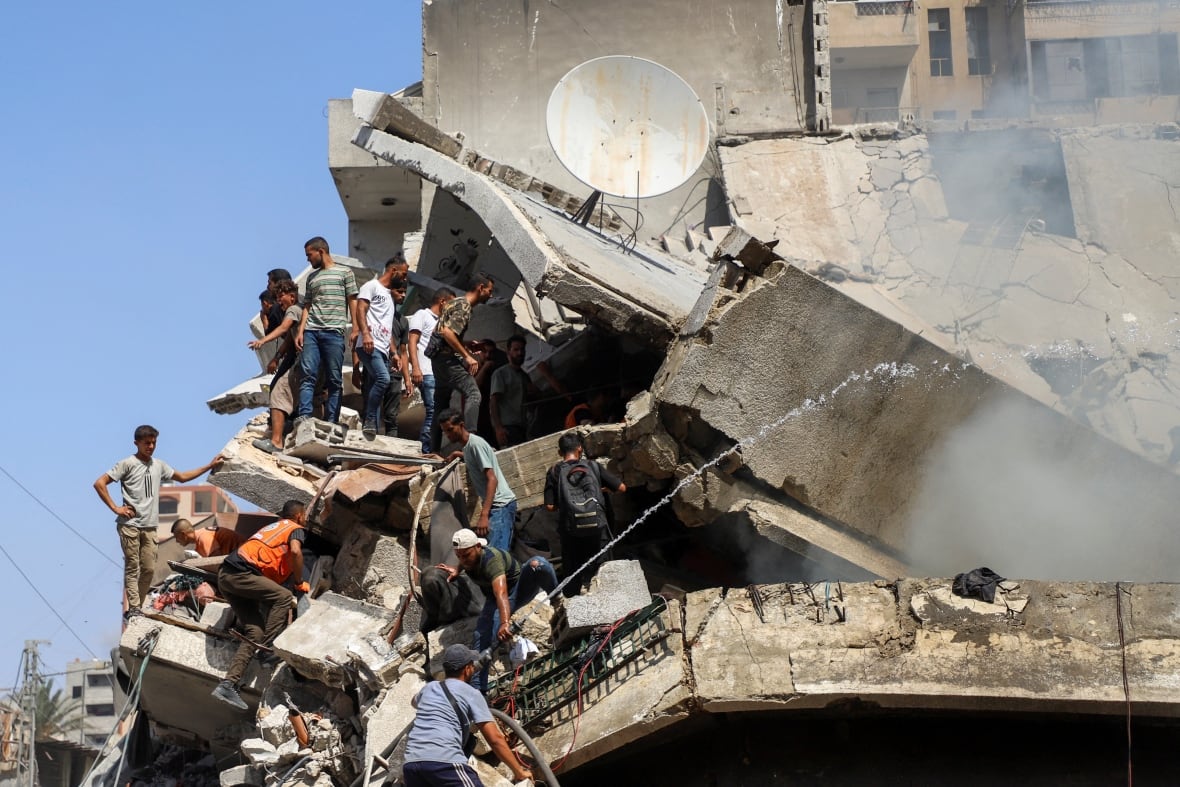 People are looking for victims in a destroyed building.
