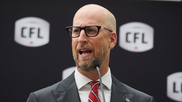 CFL Commissioner Stewart Johnston speaks at a press conference.