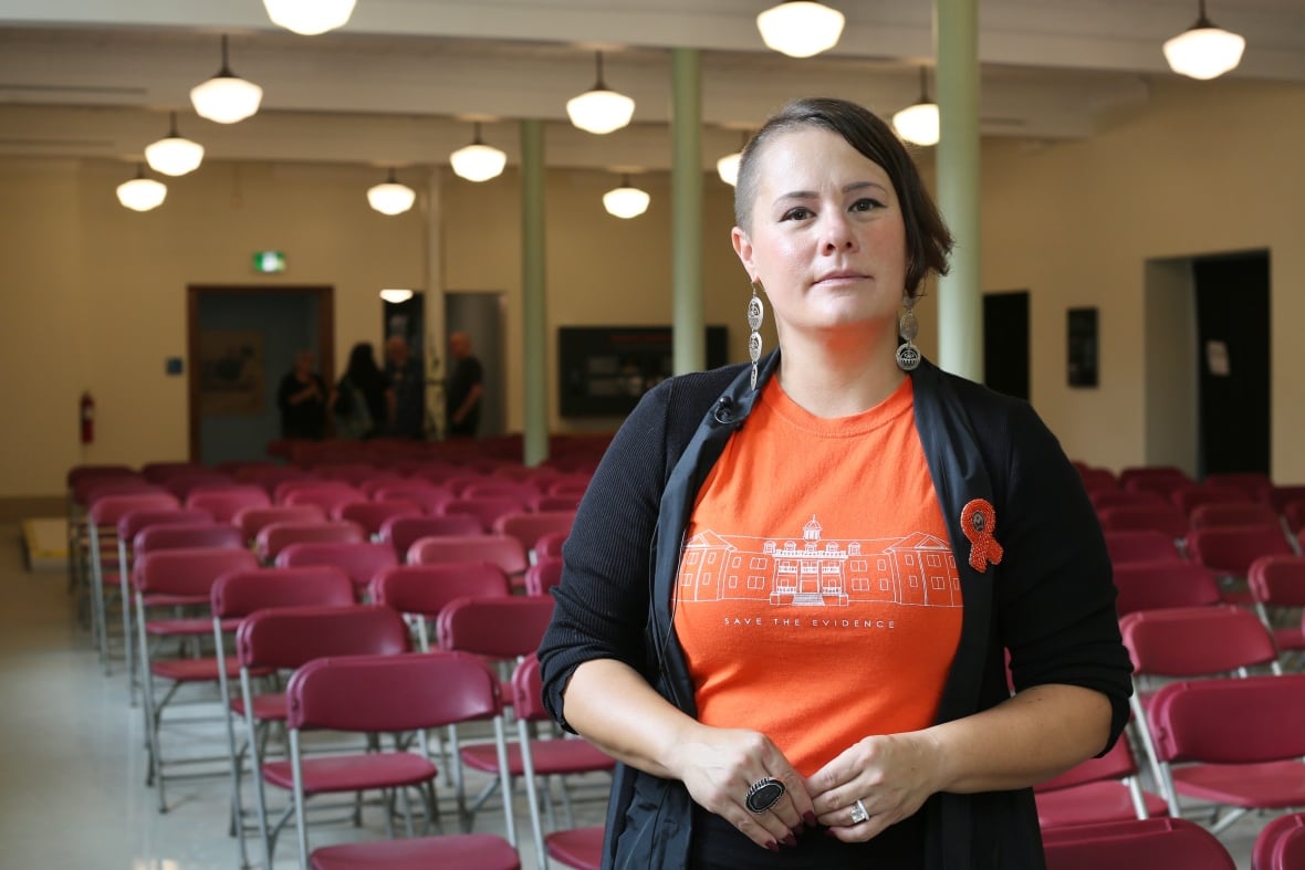 A woman looks at the camera