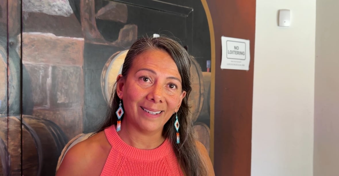 A woman smiles.