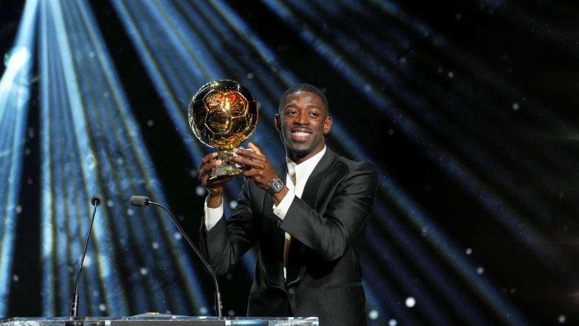 A man holds a trophy.