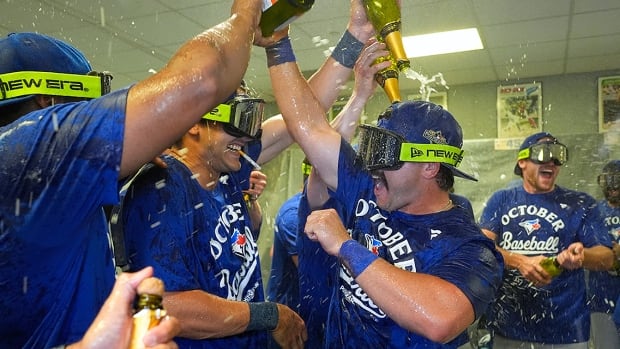 Toronto Blue Jays infielder/outfielder Davis Schneider pours champagne connected  immoderate   of his teammates portion    celebrating the team’s clinching of a playoff spot   aft  their triumph  implicit    the Kansas City Royals connected  September 21, 2025, successful  Missouri.