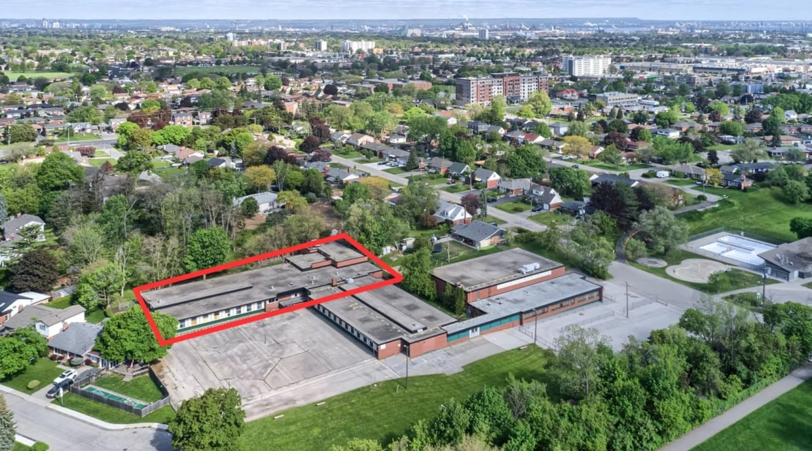 An aerial shot of a neighbourhood with a prominent big building