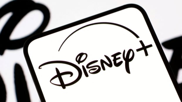 a phone screen in white with black cursive writing reads Disney+