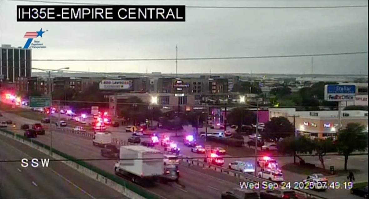 This traffic camera image shows the presence of heavy police from a highway.