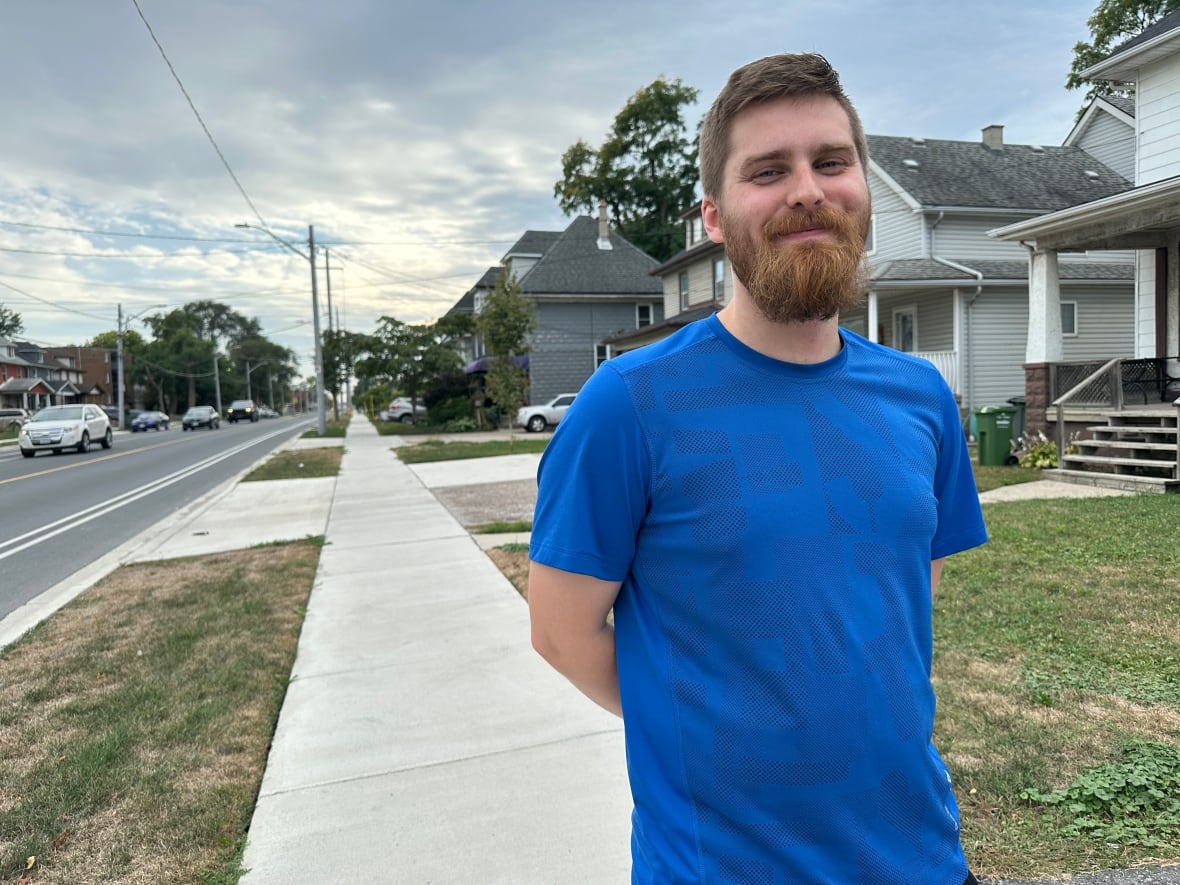 A man in a blue shirt.