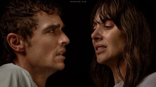 a man and a woman hold eachothers arms and grimace at eachother with scared looks on a movie poster