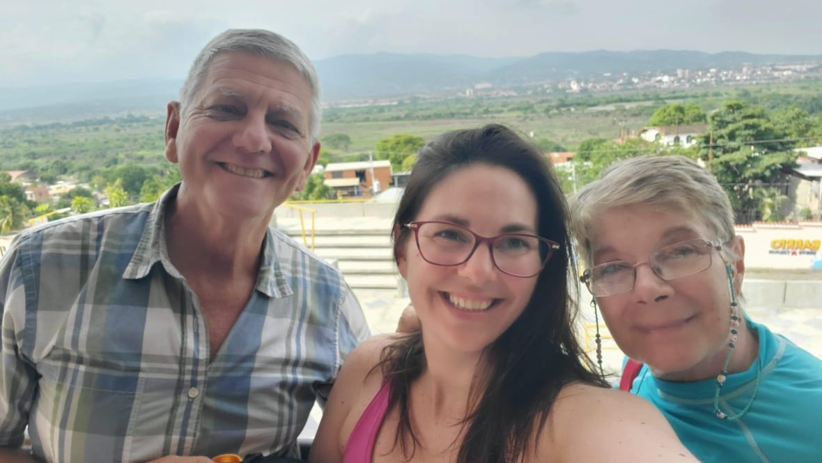 A woman with her parents. 