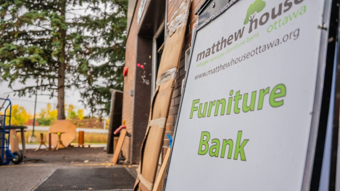 A furniture bank sign in front of a garage.