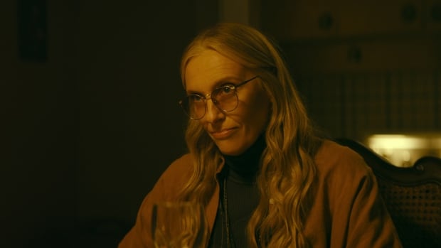 A smiling woman with long hair is shown.