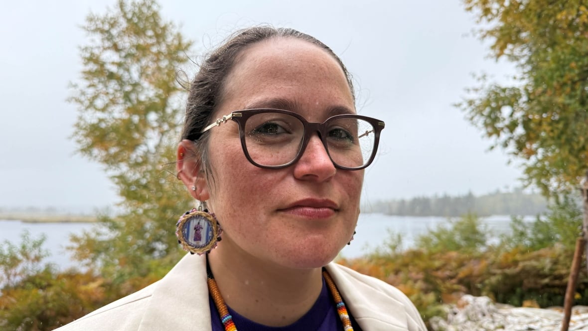 A woman poses for a photo. 