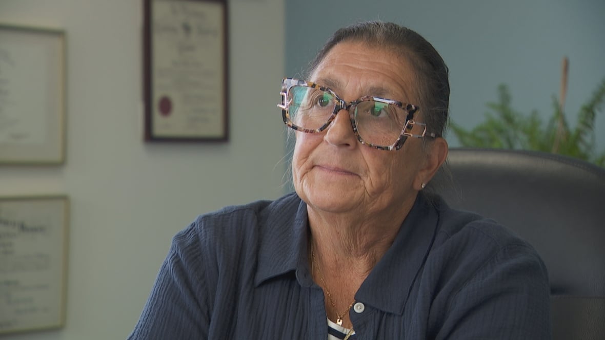 A woman speaks to a camera