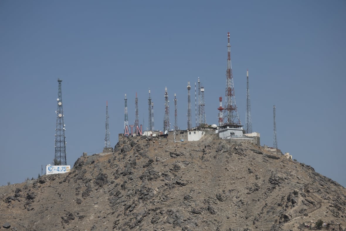 Communications antennas stand on a mountain.