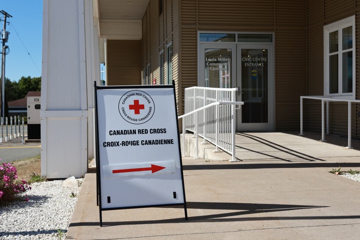 A Canadian Red Cross sign sits in front of a building entrance.