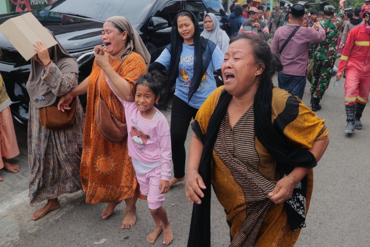 Adult women and female children appear standing on a way with expressions made on their faces.