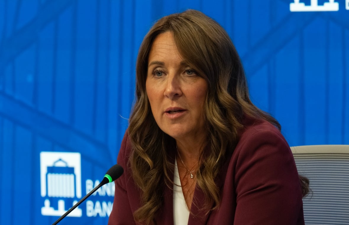 A woman speaks into a microphone.