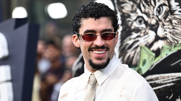 A man in sunglasses poses for a photo.
