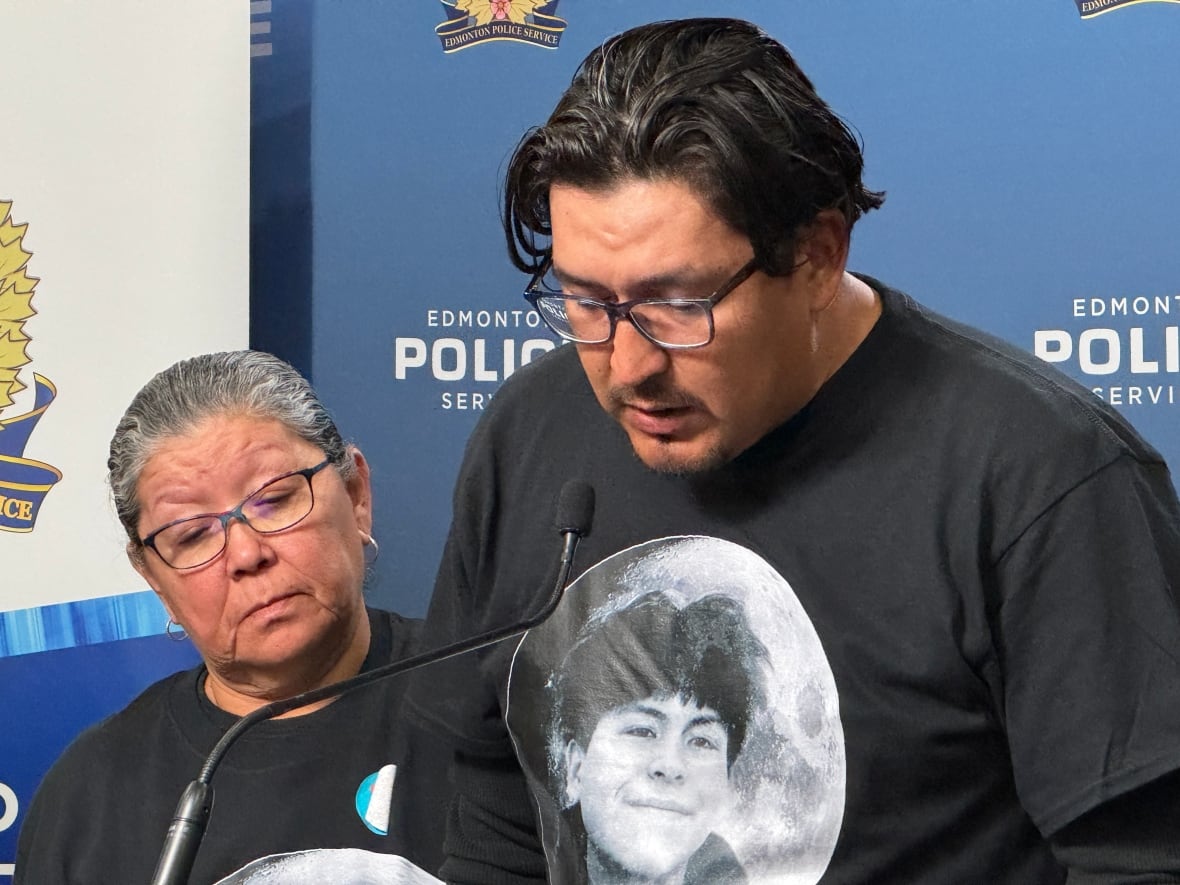 Justin Bird stands with his mother behind him at an Edmonton Police Service news conference on Wednesday. 