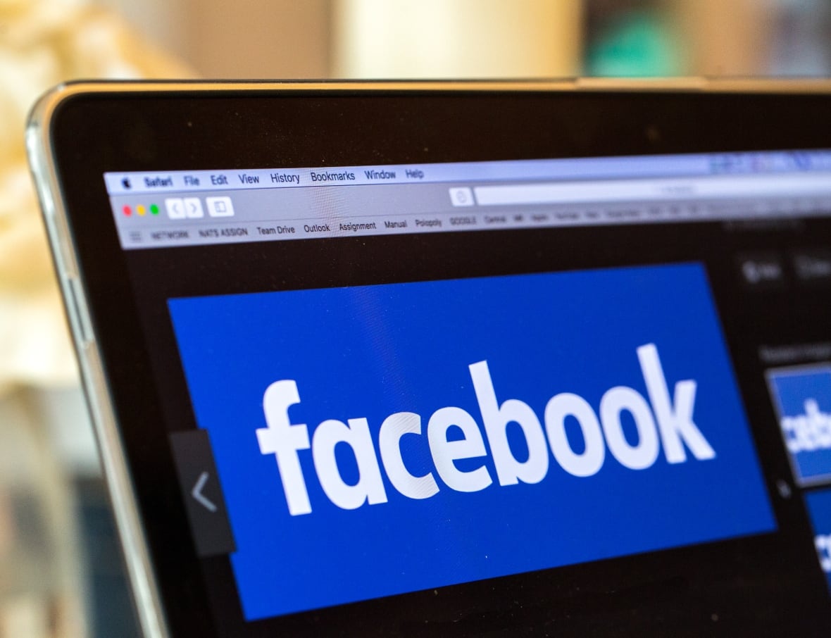 A logo on a screen reading 'Facebook'.