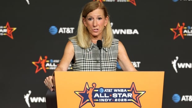 A woman speaks at a podium.
