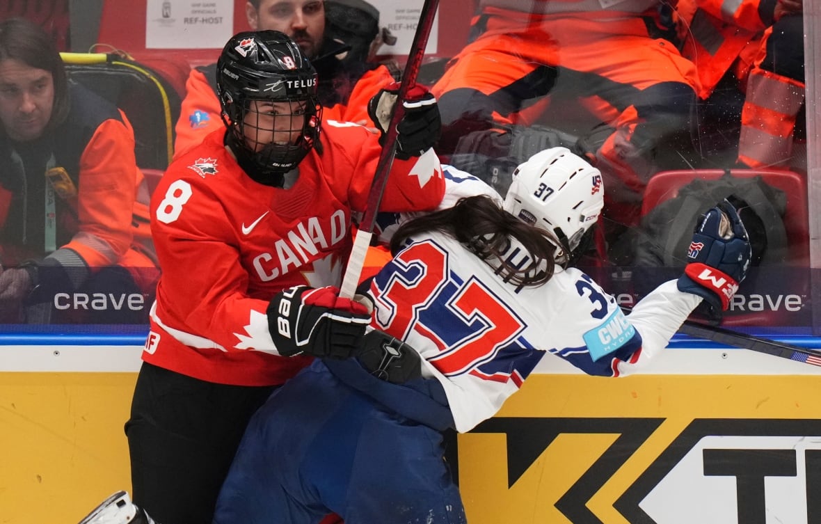 Two players collide on the boards in a hockey game.