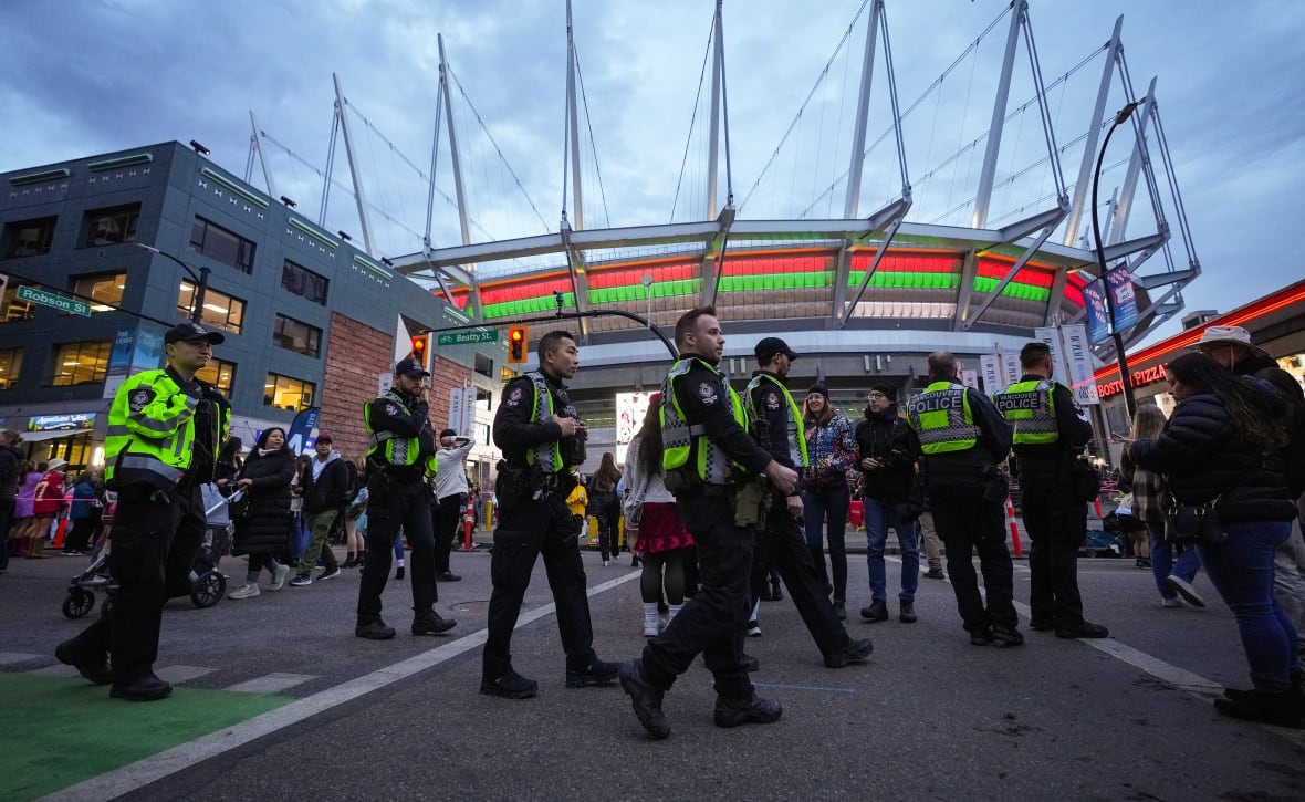 Police officers walk outside of BC Place where Taylor Swift concerts were held in 2024.