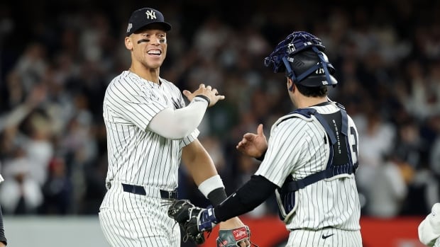 Men's baseball players are shown smiling.