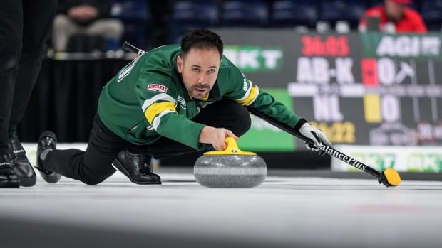 A curler throws a stone.