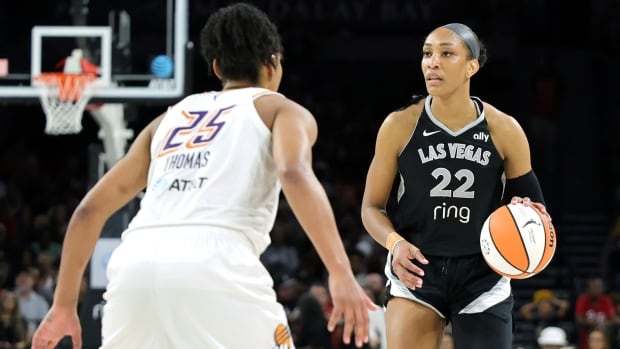 Two opposing women's basketball players are shown.