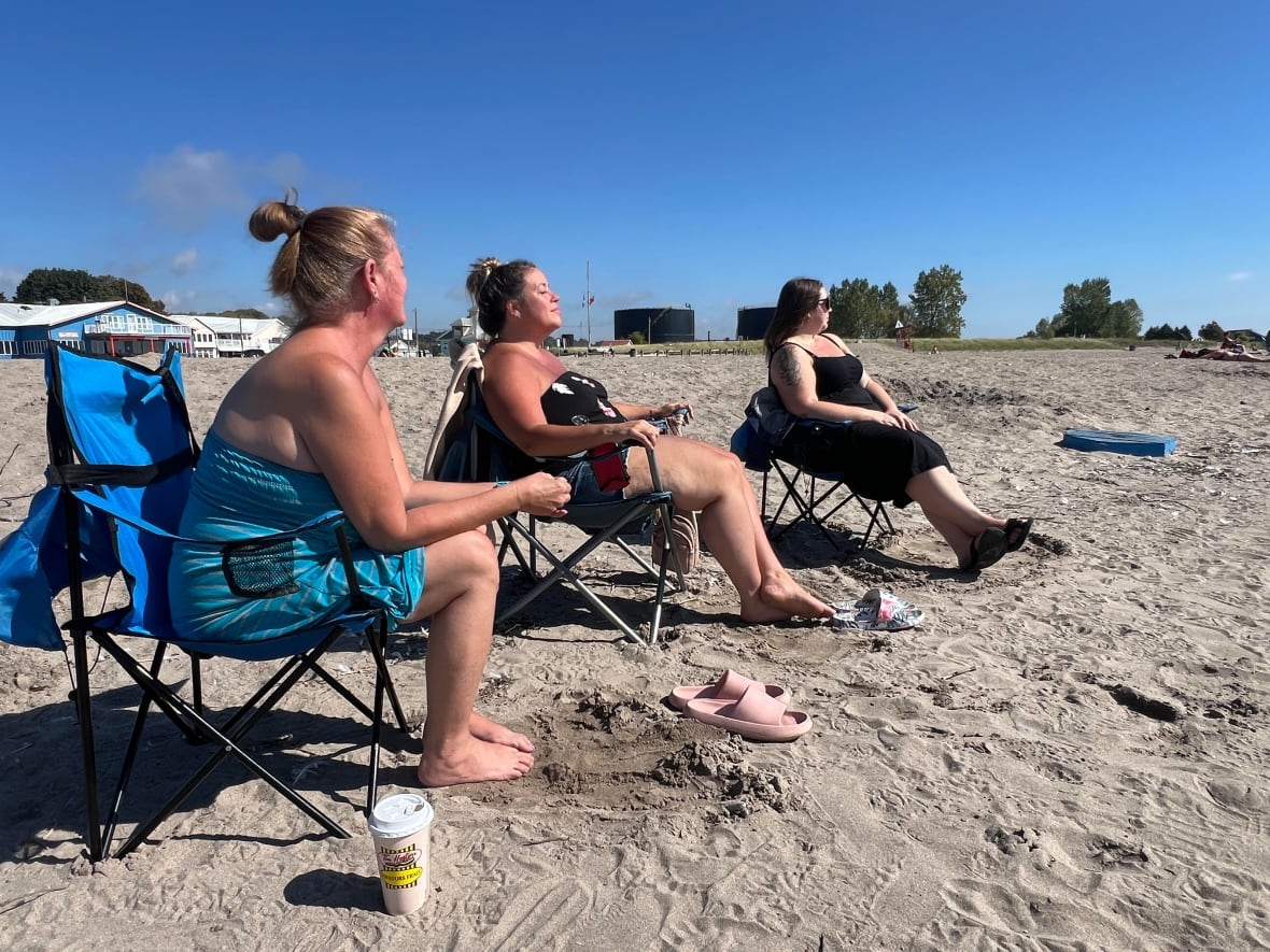 From left to right Pauline Cormier, Melissa Sparling and Rachelle Howie soak up the summer-like temperatures at Port Stanley Beach. Highs over the weekend soared to 28 C, more than 10 degrees above normal temperatures for this time of year.