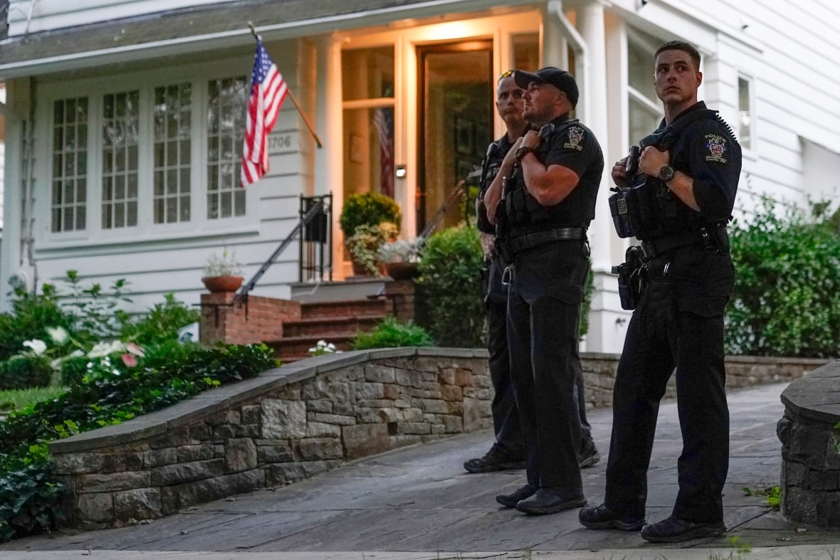 Police officers stand off the home.
