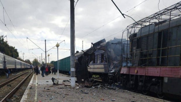 A train hit by a Russian drone strike sits damaged.