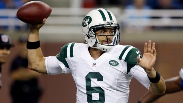 New York Jets quarterback Mark Sanchez throws during the first quarter of a preseason NFL football game against the Detroit Lions at Ford Field in Detroit, Friday, Aug. 9, 2013. (AP Photo/Carlos Osorio) A football quarterback in a white uniform with green details throws the ball.