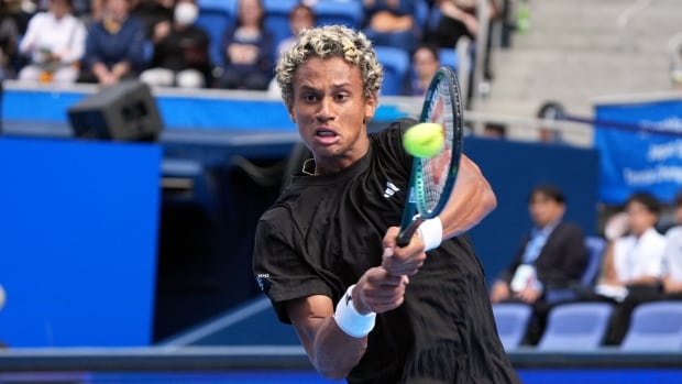 Canada's Gabriel Diallo, pictured at last month's Japan Open, will face Zizou Bergs of Belgium in the Round of 16 at the Shanghai Masters tournament on Tuesday. A male tennis player returns a shot with both hands on the racket.