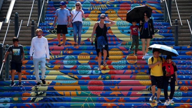 People make their way through downtown Ottawa on Monday, July 28, 2025, while temperatures hit 33 degrees. THE CANADIAN PRESS/Sean Kilpatrick