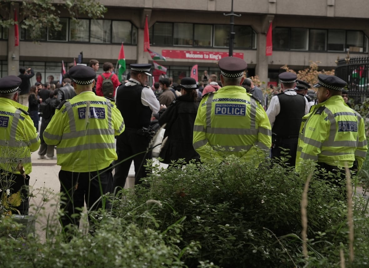 Dozens of police officers watched from the margins of Tuesday's march in central London. The British government is preparing to give the police more powers when it comes to reducing the protests. 
