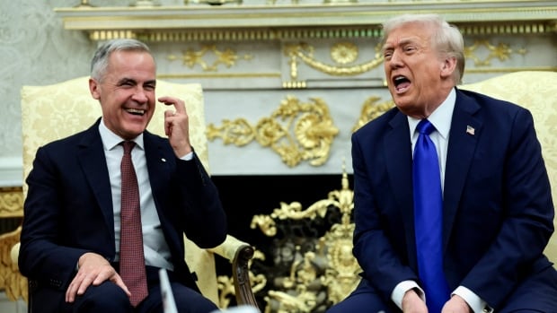 Two men laugh during a meeting