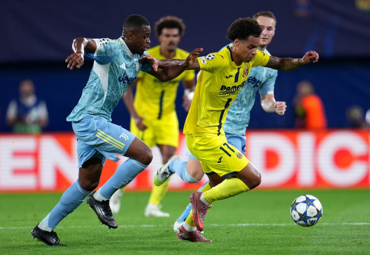 A soccer player runs with the ball.