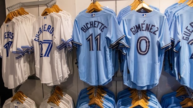 Baseball jerseys hanging in a store.