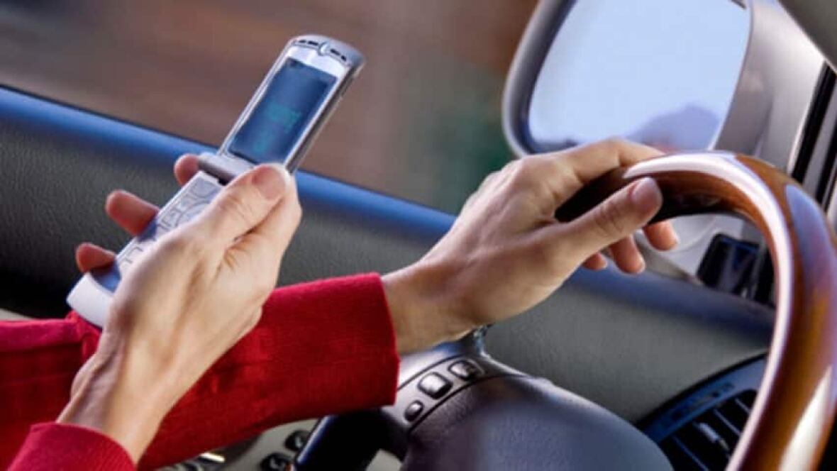 Holding cellphone in hand while driving illegal in Ontario Ottawa