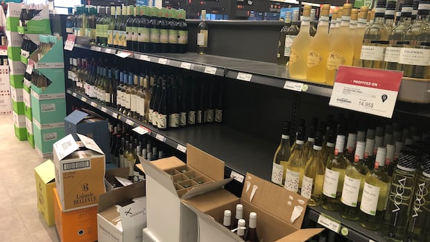 boxes of alcohol in front of SAQ shelves 