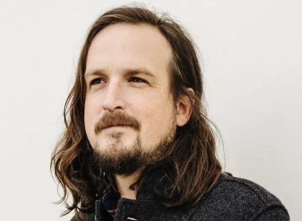 A man wearing a jacket is shown above the chest.